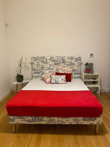a bedroom with a bed with a red blanket at Big & Modern 3 min Mc Casino apartment in Monte Carlo