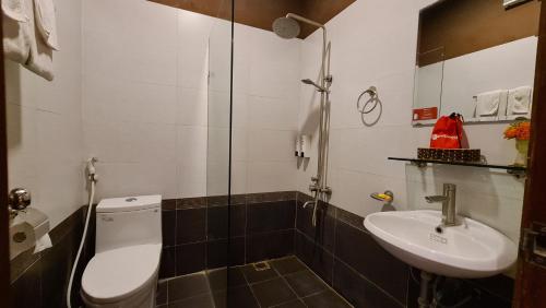 a bathroom with a toilet and a sink at Green Hotel near Lotte Center in Hanoi