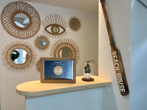 a shelf with a framed picture and mirrors on a wall at STUDIO SUR LE PORT in Le Bourget-du-Lac