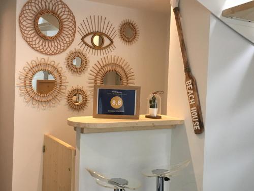 a shelf in a room with mirrors on the wall at STUDIO SUR LE PORT in Le Bourget-du-Lac