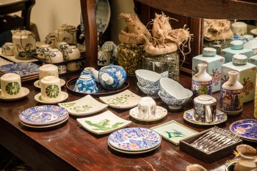 a table topped with blue and white plates and bowls at Amanaki Saigon Boutique Hotel in Ho Chi Minh City