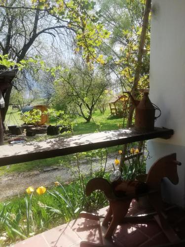 a window sill with a view of a garden at Fecskefészek Vendégház Őriszentpéter in Őriszentpéter