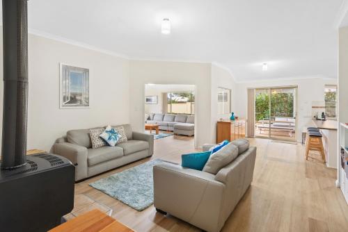 a living room with two couches and a television at Seachange in Dunsborough