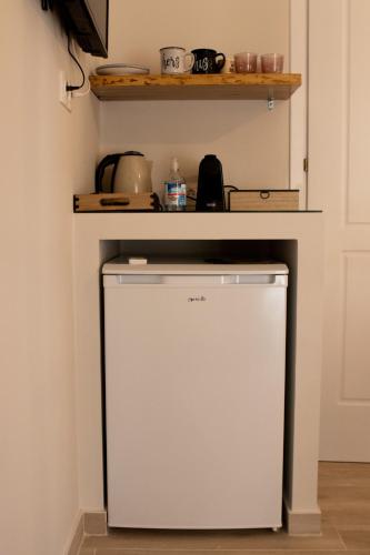 a small refrigerator under a counter in a kitchen at Langhi Apartments 2 in Mesolongion