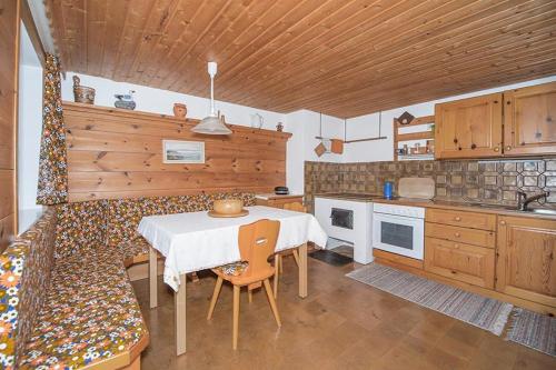 a kitchen with a table and chairs in a room at Haus am Wörtherberg in Rauris