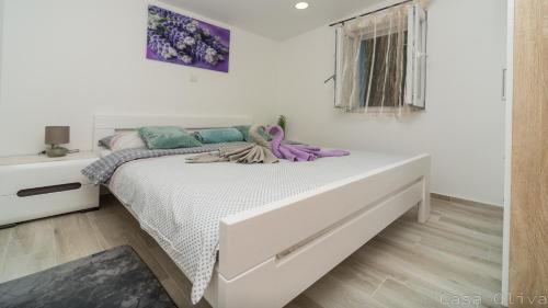 a white bedroom with a large bed in a room at Holiday Home Casa Oliva II in Nerezine