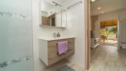 a bathroom with a sink and a mirror at Holiday Home Casa Oliva II in Nerezine