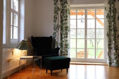 a living room with a chair and a large window at Forsthaus in Waldhessen in Bauhaus
