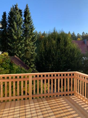 a wooden fence on a deck with trees in the background at Forsthaus in Waldhessen in Bauhaus