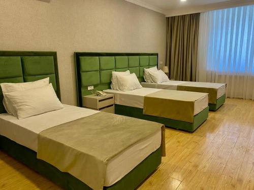 a hotel room with two beds in a room at Rusel Park Hotel in Baku