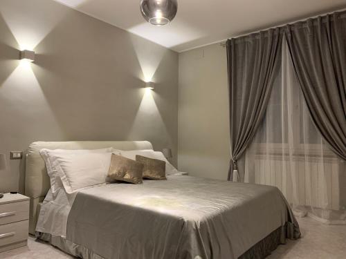 a bedroom with a bed with two pillows on it at Green Oasis Gabella in Castelforte