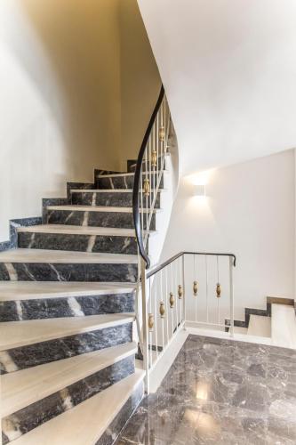 a staircase in a house with marble flooring at Olympus Residence in Athens