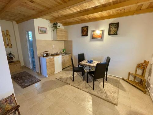 a kitchen and dining room with a table and chairs at Sunlight Cottage Maya in Virpazar