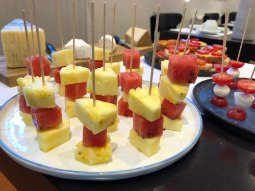 a plate of fruit appetizers on a table at Villa 7 in Flachau