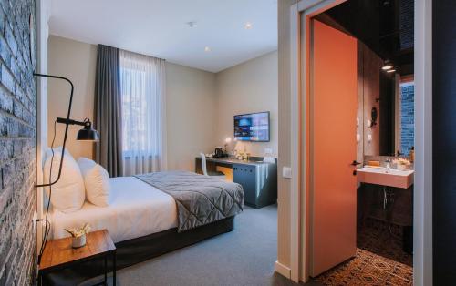a hotel room with a bed and a sink at TbiliSee Hotel in Tbilisi City