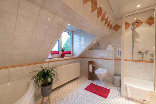 uma casa de banho com uma banheira, um WC e um lavatório. em Landhaus Jägerhof em Börnsdorf