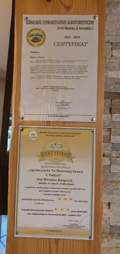a sign for a restaurant with a menu at Agroturystyka na Słonecznej Orawie u Dzikich in Jabłonka