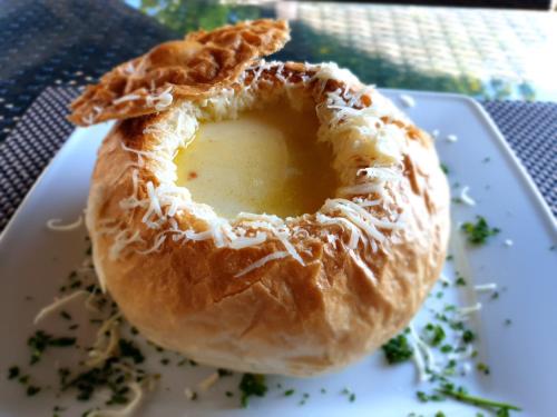 a croissant on a plate on a table at Hotel Opal Superior - Adults Only in Gyöngyös