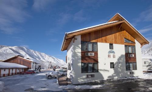 a building in the snow with mountains in the background at Starlight Lodge in Glenwood Springs