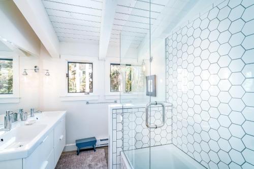 a white bathroom with a shower and a sink at Deer Park - Ski Ranches in Telluride