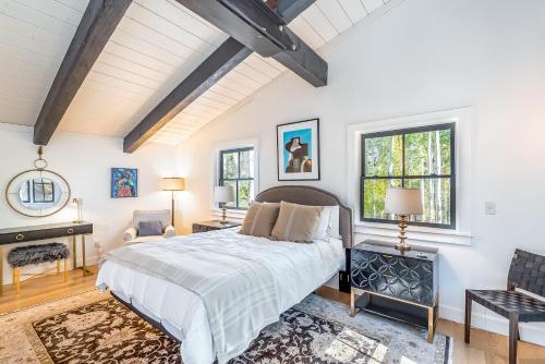 a bedroom with a large bed and two windows at Deer Park - Ski Ranches in Telluride