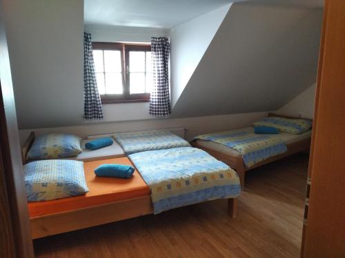 a bedroom with two beds and a window at Apartmán Alva 3 in Mikulov