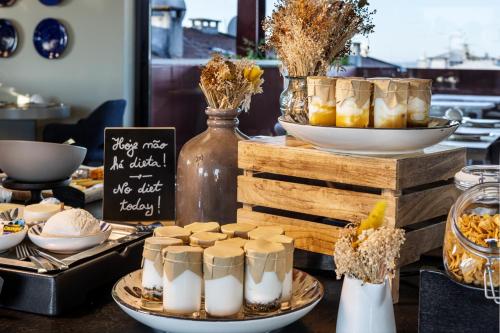 a buffet with cheese and other food items on a table at Vitoria Stone Hotel in Évora