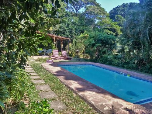 a swimming pool in the backyard of a house at St Lucia Wilds in St Lucia