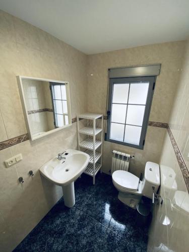 a bathroom with a sink and a toilet and a mirror at Casa RIVER VIEW - Cazorla in Cazorla