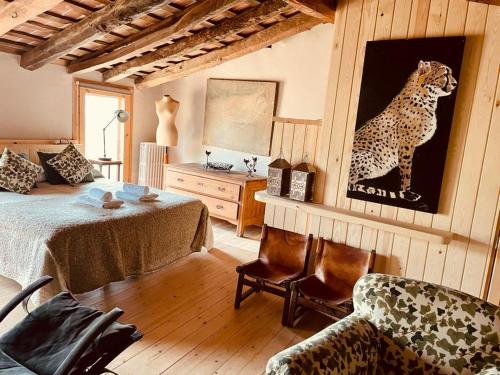 a bedroom with a cheetah painting on the wall at Brugarolas Village in Castelltersol