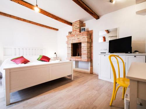 a bedroom with a bed and a fireplace at Val Comeza in Komiža