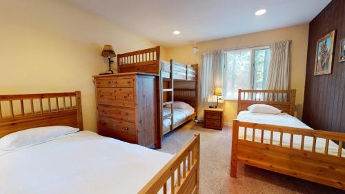 a bedroom with two beds and a bunk bed at Chateau De Montagne #23 Condo in Mammoth Lakes