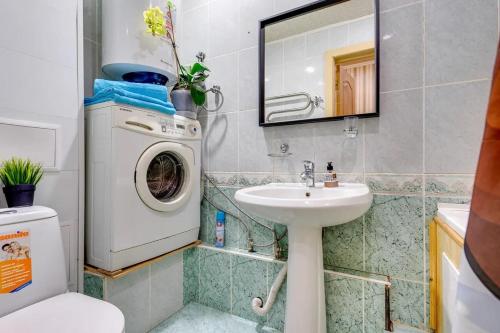 a bathroom with a washing machine and a sink at Квартира в центре in Kazan