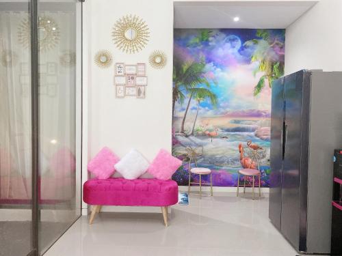 a living room with a pink couch and a painting at RSY guesthouse The argopuro in Berpodak