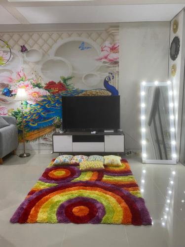 a living room with a colorful rug on the floor at RSY guesthouse The argopuro in Berpodak