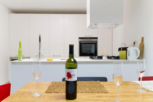 a bottle of wine sitting on a table with two wine glasses at Bale Luxury House in Bale