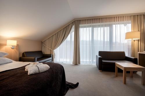 Ένα ή περισσότερα κρεβάτια σε δωμάτιο στο Hotel BUKOVINA