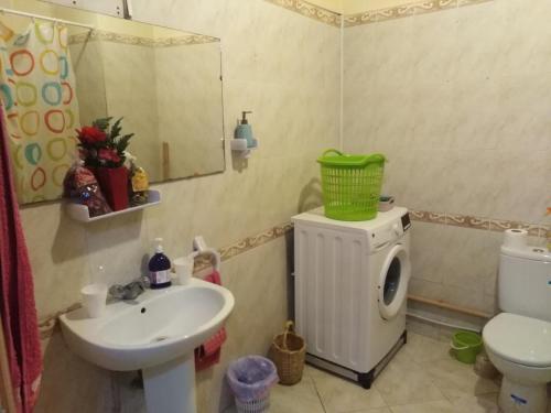 a bathroom with a sink and a washing machine at Appartement au centre Agadir résidence privée in Agadir