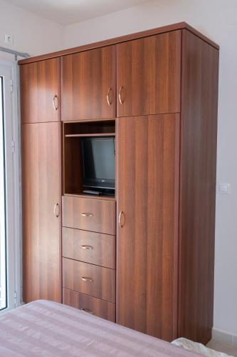 a large wooden cabinet with a television in it at Christina's place in Sami