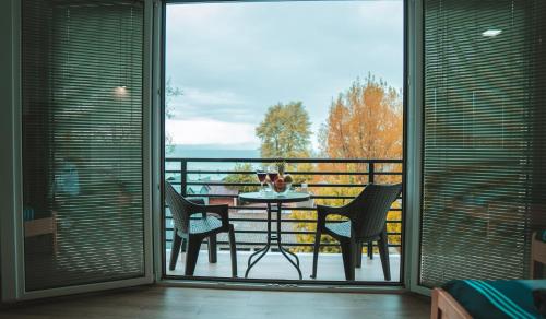 a balcony with a table and chairs on a balcony at Villa Natali in Ohrid