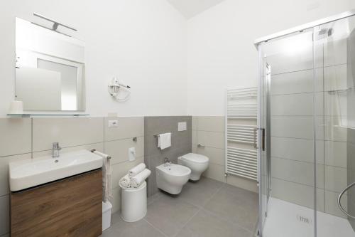 a bathroom with two toilets and a sink and a shower at Residence OndaMare in Cervia