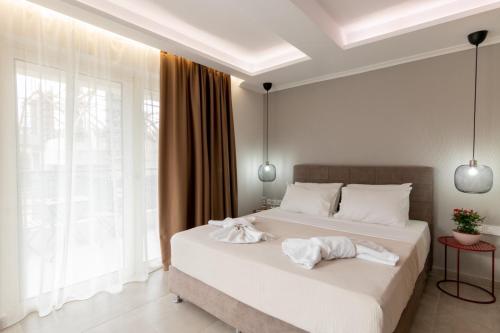 a bedroom with two beds with white towels on them at Elite City Apartments & Maisonettes by Imagine Lefkada in Lefkada Town
