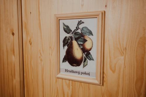 a picture of a pears hanging on a wall at Penzion Brusinka in Kocourov