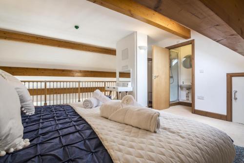 a bedroom with a large bed with pillows on it at Marina View - 3 Bedroom Apartment - Milford Marina in Milford Haven