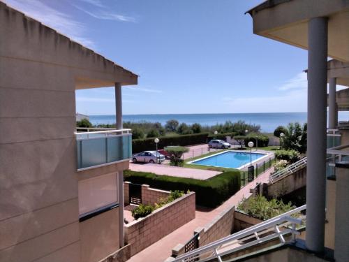a view of the pool from a building at Apartamento frente al mar in Les Cases d'Alcanar