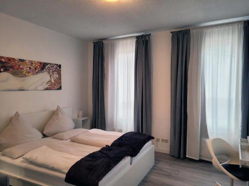 a bedroom with a bed and a large window at Hotel Restaurant Adria Kroatien in Bad Ems