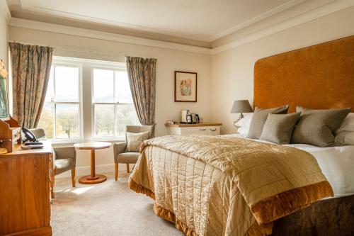 a bedroom with a large bed and a window at The Lovat, Loch Ness in Fort Augustus