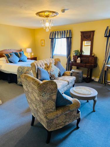 a living room with a couch and a bed at Softleys in Market Bosworth