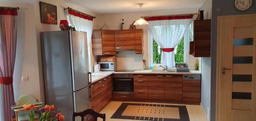 a kitchen with a stainless steel refrigerator and a window at Agroturystyka na Słonecznej Orawie u Dzikich in Jabłonka