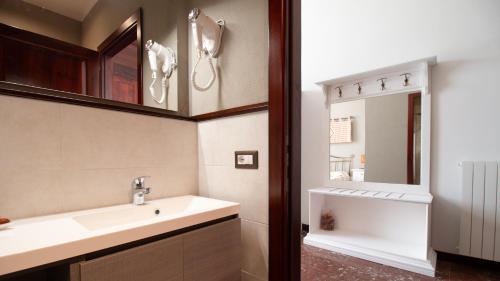 a bathroom with a sink and a mirror at Sardinianworld - Cocco e Dessi Home in Oristano